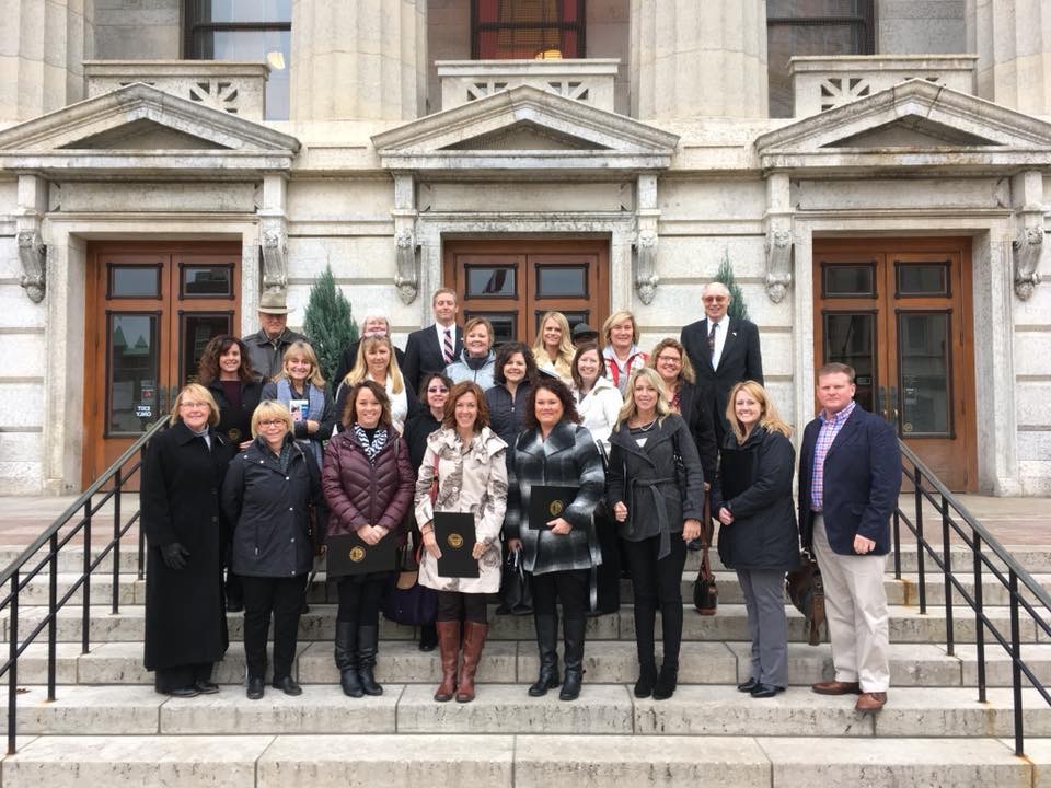 teachers in front of building